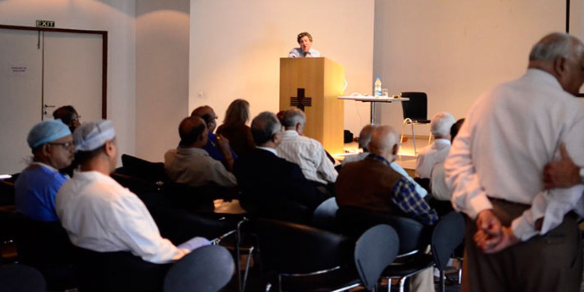 A Bio-Neuro Feedback seminar at SFCT: a speaker addressing a seated audience from a lectern.